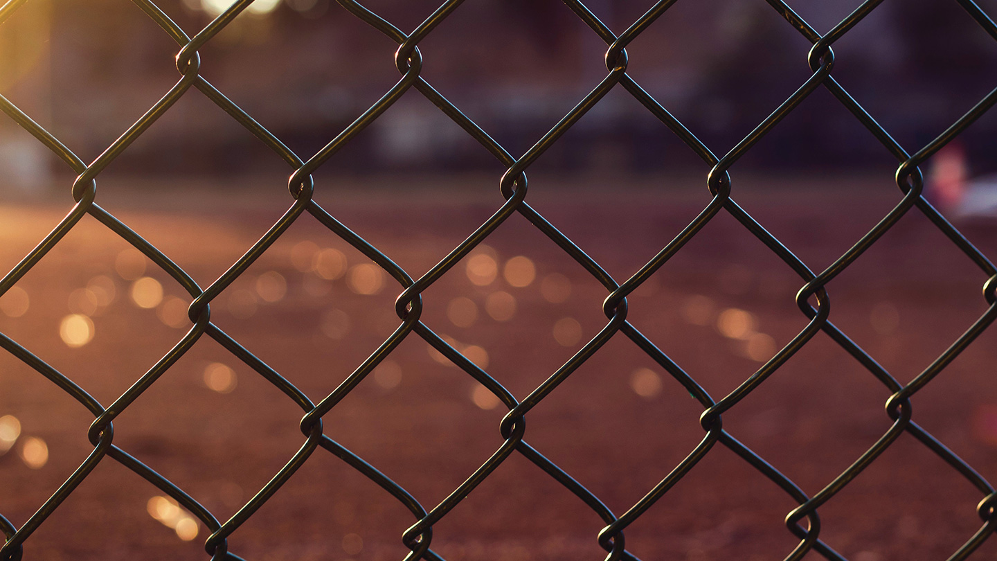 Chainlink fence with sunset